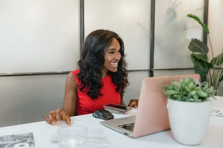 Entrepreneur at desk smiling while working